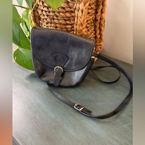 Black vera Pelle Italian leather crossbody bag with buckle closure.